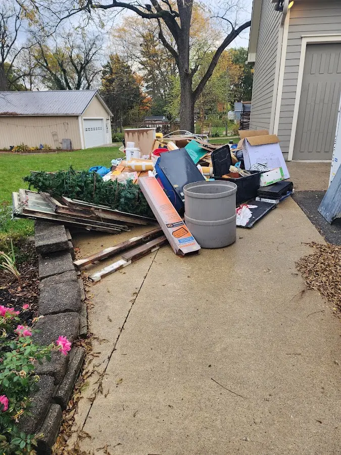 Dumpster being loaded with debris for Estate Cleanout Dumpster Rental in Eaton